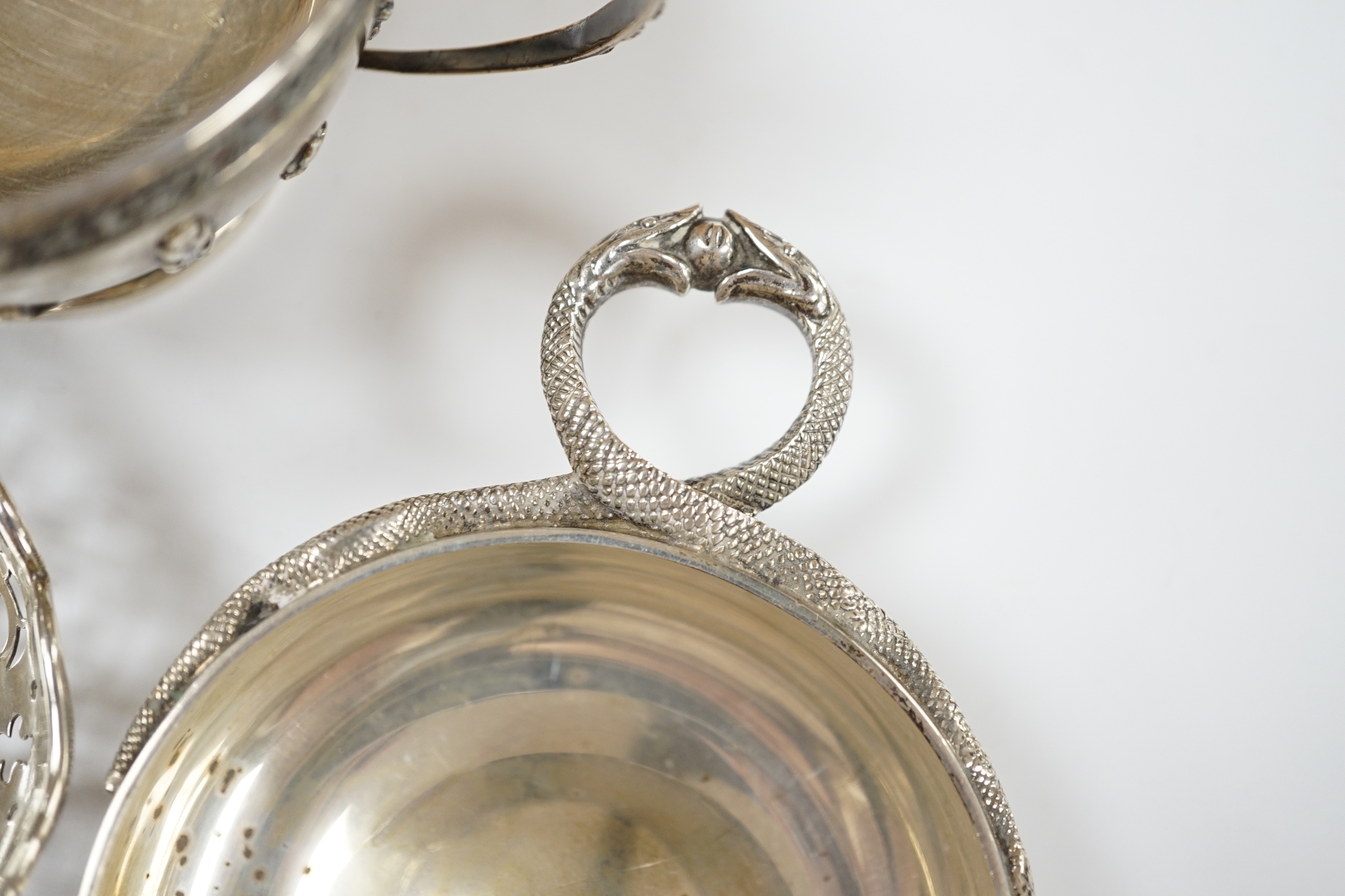 An Edwardian repousse silver porringer, Daniel & John Welby, London, 1905, diameter 92mm, a pair of pierced silver bonbon dishes, one other similar bonbon dish, a silver two handled bowl and a modern silver taste vin